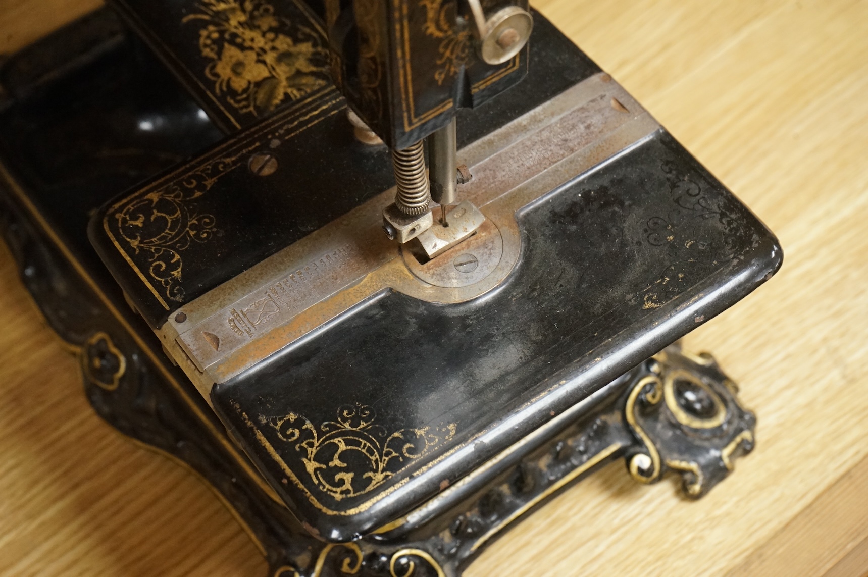 A late 19th century Wanzer sewing machine, in black enamel with gilt decoration.